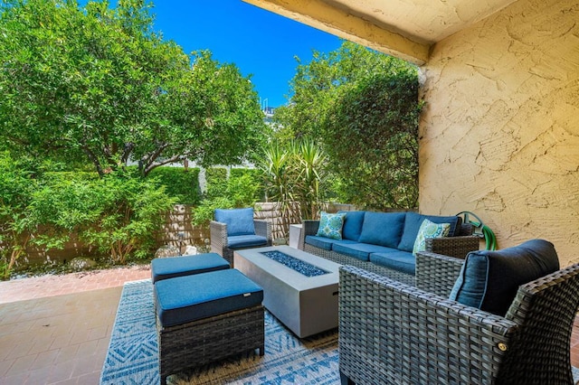 view of patio / terrace with an outdoor living space with a fire pit