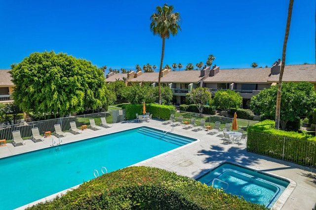 view of pool featuring a community hot tub and a patio