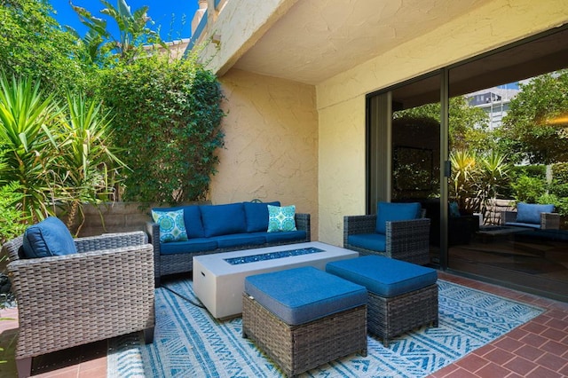 view of patio / terrace with an outdoor living space with a fire pit