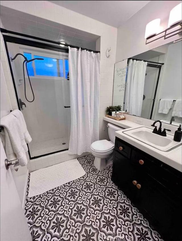 bathroom featuring tile patterned flooring, vanity, a shower with curtain, and toilet