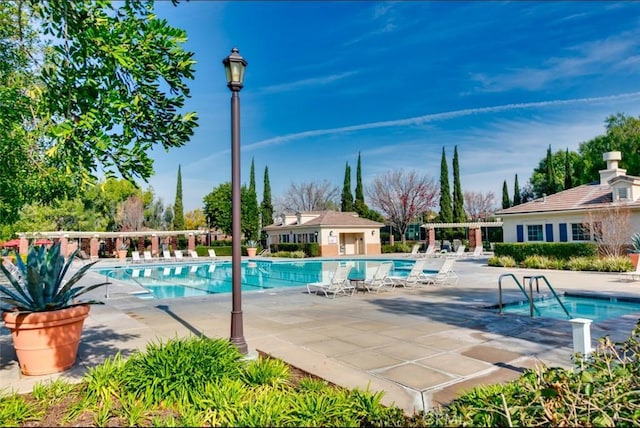 view of pool with a pergola and a patio area