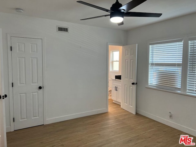 empty room featuring ceiling fan and light wood-type flooring