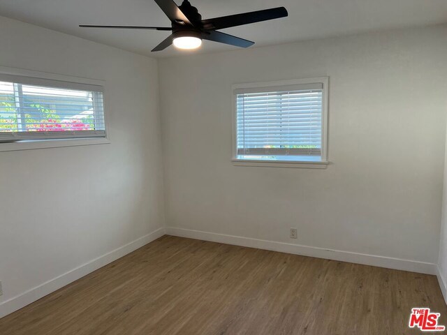 unfurnished room with ceiling fan and light wood-type flooring