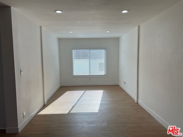 spare room featuring wood-type flooring