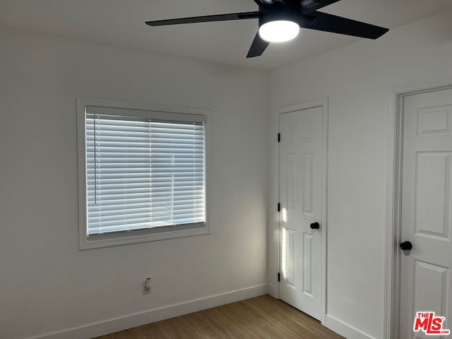 unfurnished bedroom with ceiling fan and light hardwood / wood-style flooring