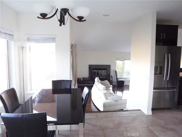 tiled dining area with a notable chandelier