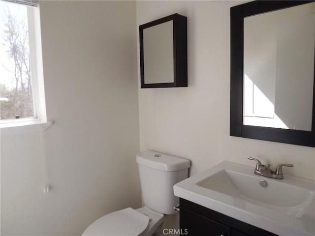 bathroom with toilet and vanity