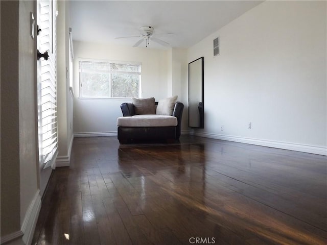 sitting room featuring ceiling fan, a wealth of natural light, and dark hardwood / wood-style floors