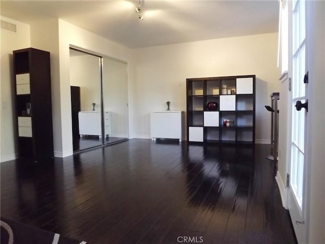 spare room with dark hardwood / wood-style flooring