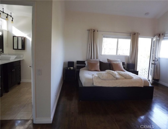 bedroom with dark hardwood / wood-style floors and sink