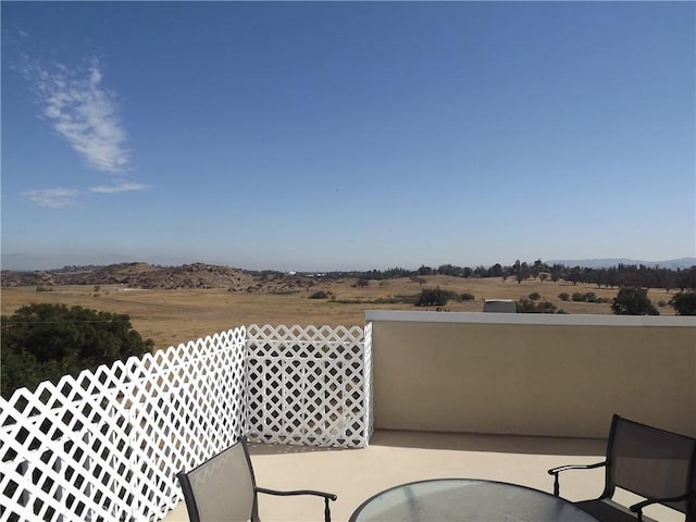 balcony featuring a patio area and a rural view