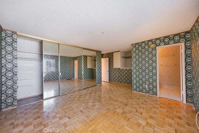 empty room featuring a textured ceiling and parquet floors