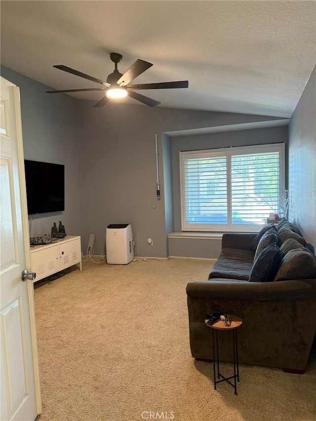 carpeted living room featuring lofted ceiling and ceiling fan