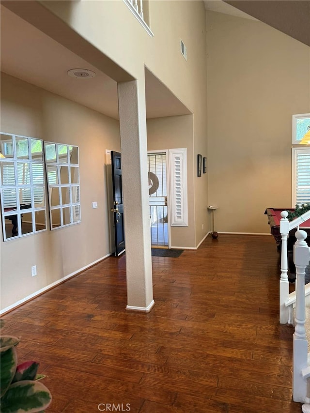 foyer featuring vaulted ceiling, dark hardwood / wood-style flooring, and billiards