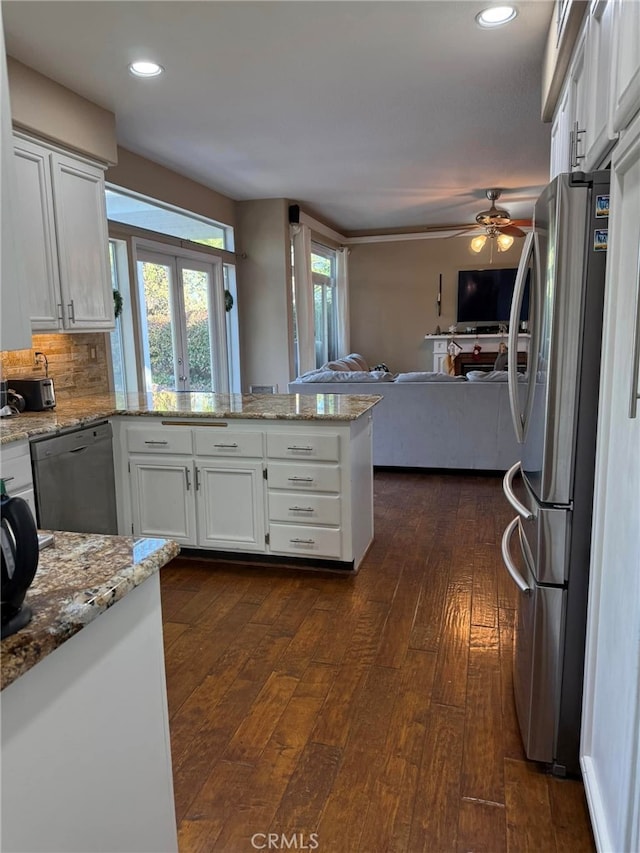 kitchen with ceiling fan, stainless steel refrigerator, white cabinetry, dark wood-type flooring, and dishwashing machine