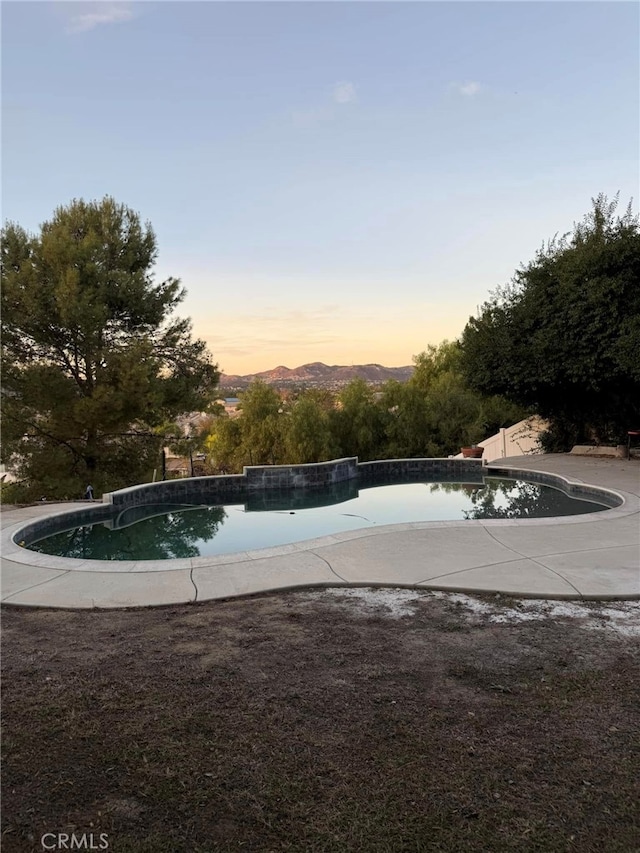 view of pool at dusk