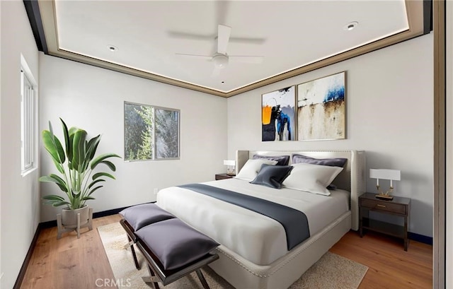 bedroom with ceiling fan and wood-type flooring