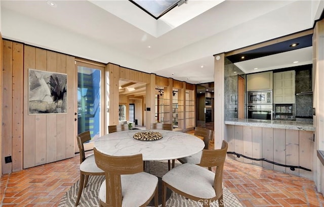 dining room with wooden walls