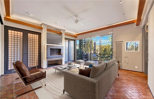 living room with ceiling fan and french doors