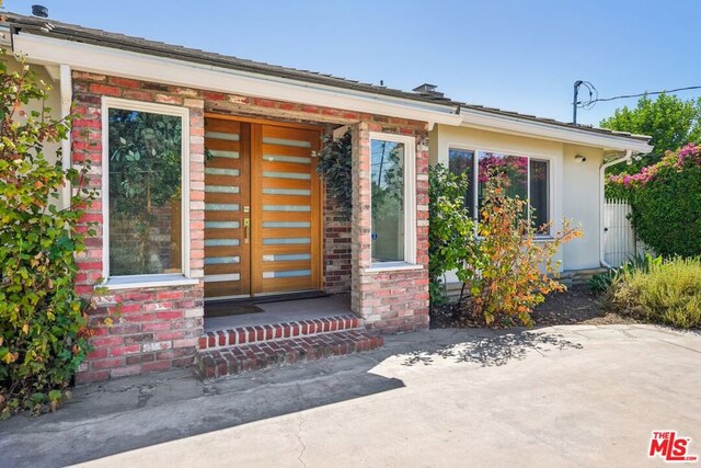 doorway to property with a patio