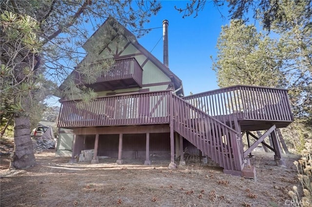 rear view of property with a wooden deck