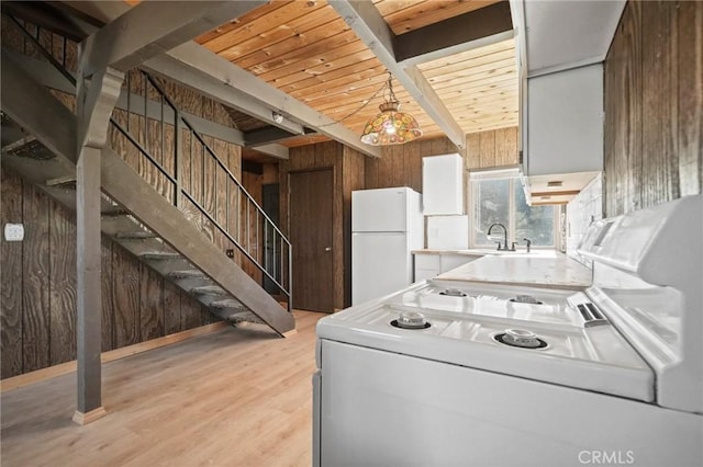 kitchen with wood ceiling, white refrigerator, wood walls, light hardwood / wood-style flooring, and beam ceiling