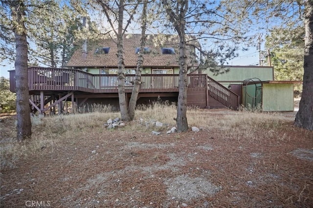 rear view of property featuring a deck