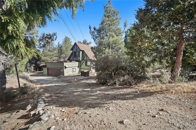 view of side of home featuring a garage