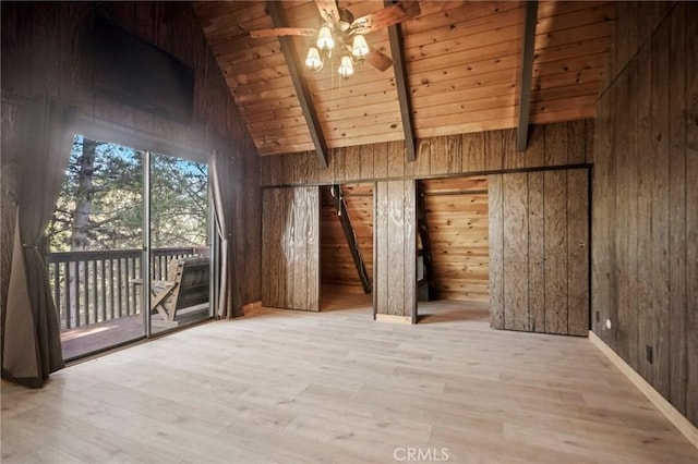 interior space with ceiling fan, wood ceiling, wooden walls, and beamed ceiling