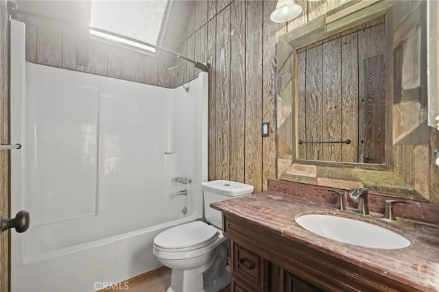 full bathroom with toilet, vanity, and bathing tub / shower combination