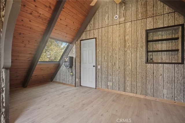 bonus room featuring wooden ceiling, vaulted ceiling with beams, and wooden walls