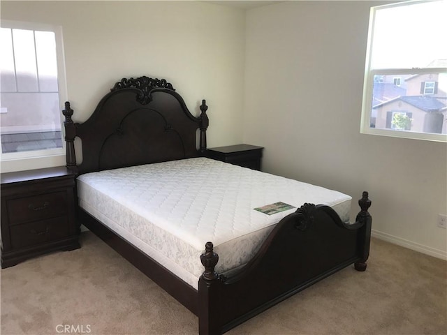 carpeted bedroom with multiple windows