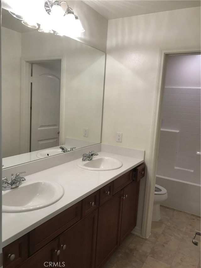 full bathroom featuring toilet, vanity, and bathtub / shower combination