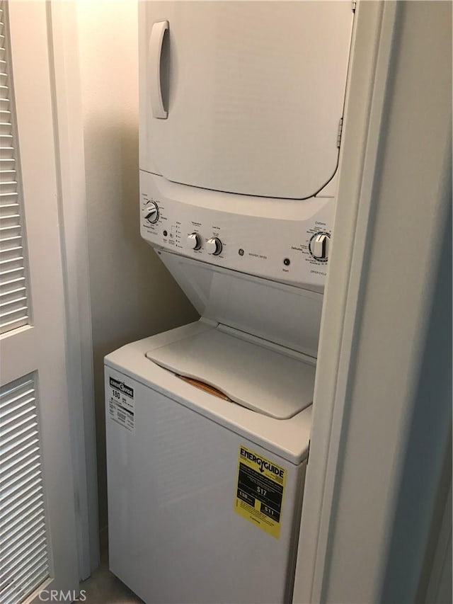 washroom featuring stacked washer / dryer