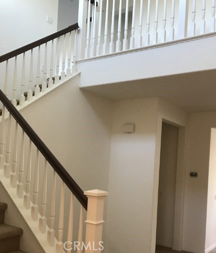 stairs featuring a towering ceiling