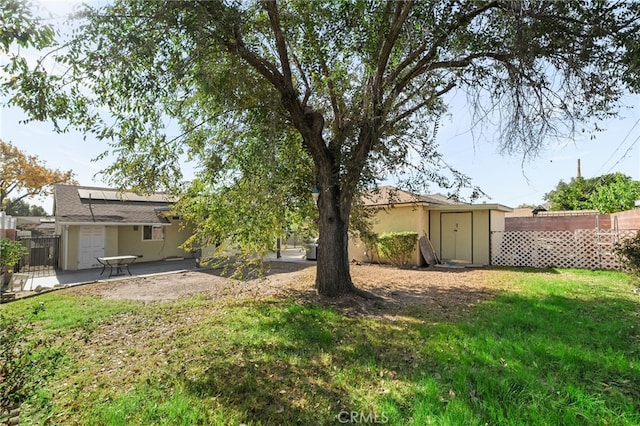 view of yard with a storage shed and a patio