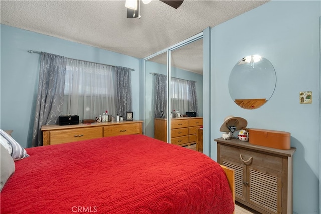 bedroom with ceiling fan, a closet, and a textured ceiling