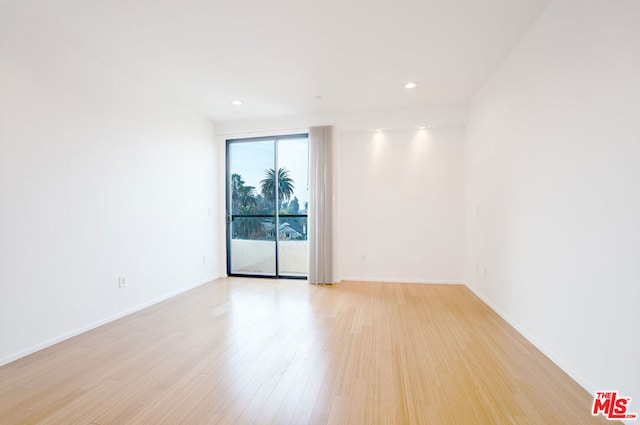 spare room with light hardwood / wood-style flooring