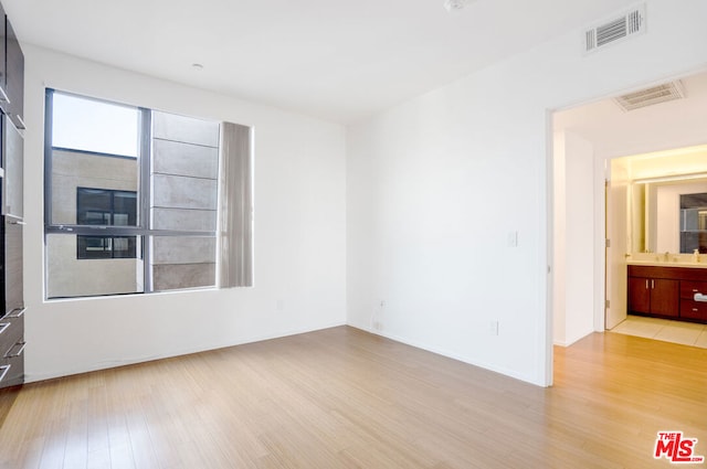 spare room featuring light hardwood / wood-style floors