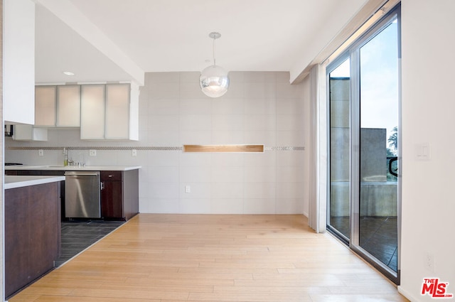 kitchen with light hardwood / wood-style floors, stainless steel dishwasher, pendant lighting, white cabinetry, and dark brown cabinetry