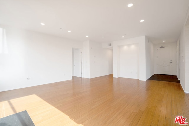 empty room with hardwood / wood-style floors