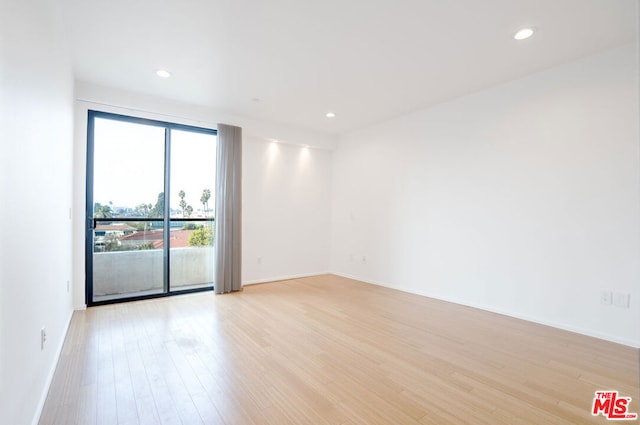 unfurnished room with light wood-type flooring