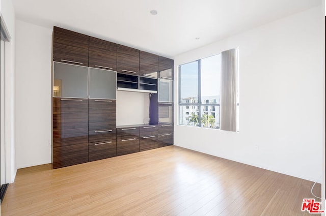 unfurnished bedroom with a closet and light hardwood / wood-style flooring