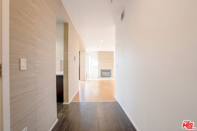 hallway with dark hardwood / wood-style flooring