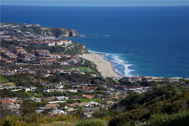 birds eye view of property with a water view and a view of the beach