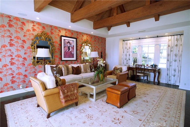 living room featuring vaulted ceiling with beams and light hardwood / wood-style flooring