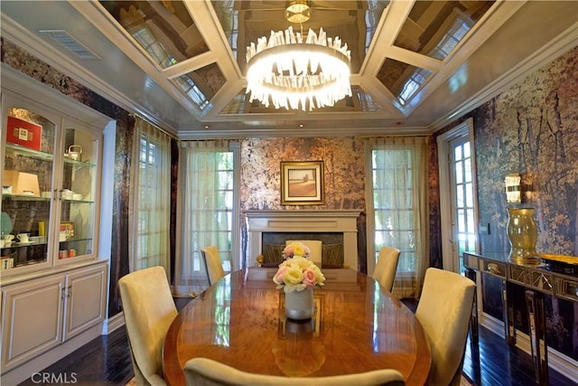 dining room with dark wood-type flooring, coffered ceiling, ornamental molding, beamed ceiling, and a notable chandelier