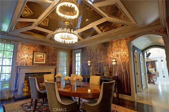 dining space featuring hardwood / wood-style flooring, an inviting chandelier, and ornamental molding