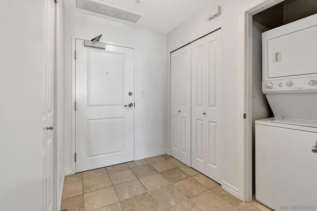 laundry area featuring stacked washer / dryer