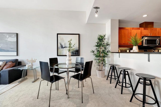 dining space with light carpet